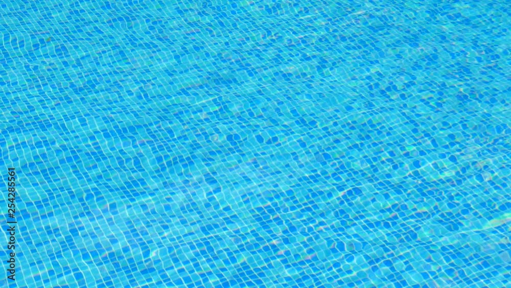 Tiled pool bottom viewed through the pool waves Tiled pool bottom viewed through the pool waves