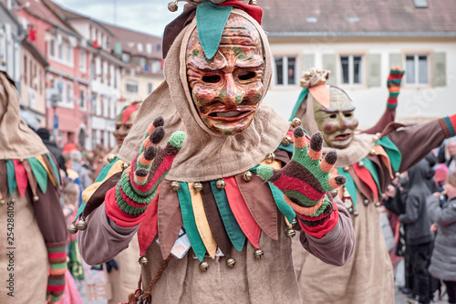 Friendly carnaval figure shows hands. Street carnival in southern Germany - Black Forest.