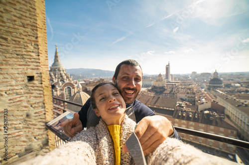 Obraz na płótnie happy tourist visiting north Italy piedmont region taking selfie with the city c