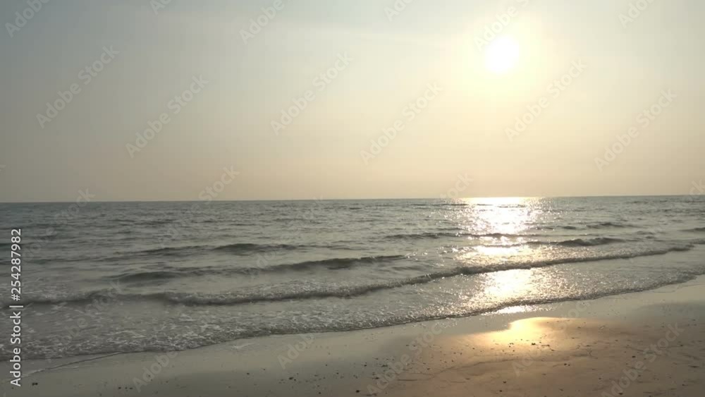 Sun reflecting off of waves rolling onto an island beach during sunset Sun reflecting off of waves rolling onto an island beach during sunset