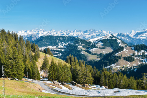 Beautiful spring panoramic view of snow-capped mountains in the Swiss Alps.