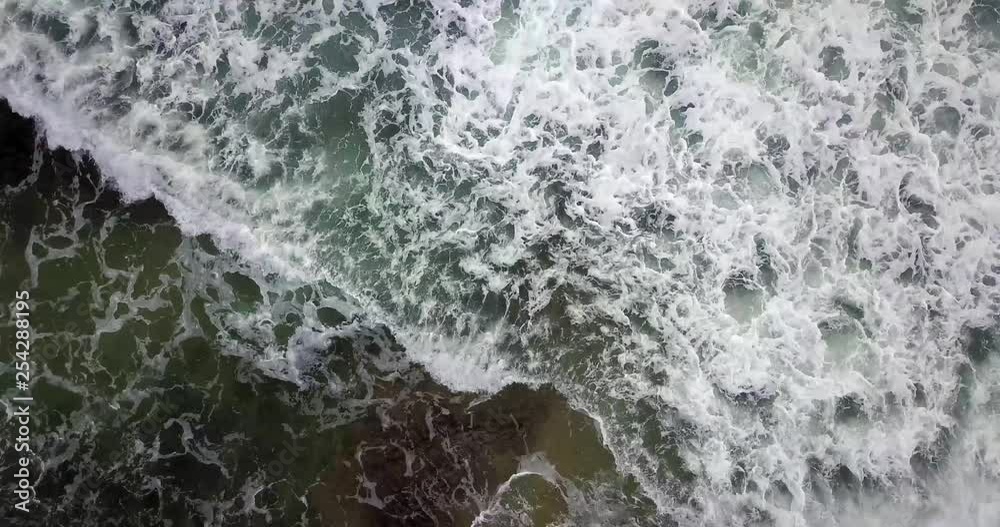 4K Hovering above hypnotic water crashing on shoreline 4K Hovering above hypnotic water crashing on shoreline