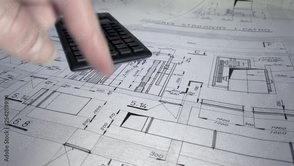 A mans hand pointing to various locations on a commercial blueprint and explaining the plan. A mans hand pointing to various locations on a commercial blueprint and explaining the plan.