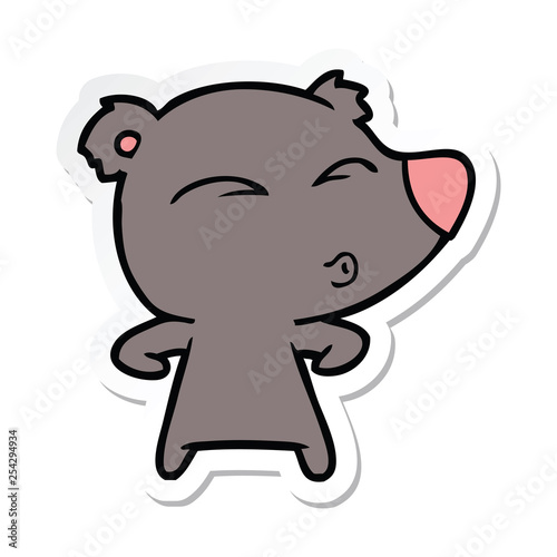 sticker of a cartoon whistling bear