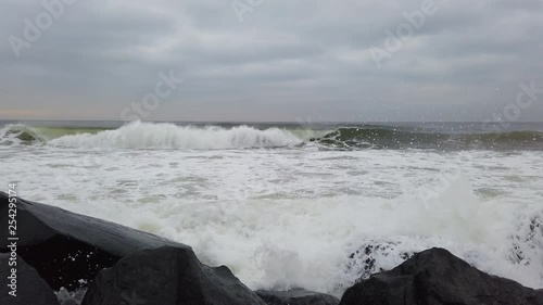 Slo mo video of waves crashing on jetting in long branch New Jersey photo