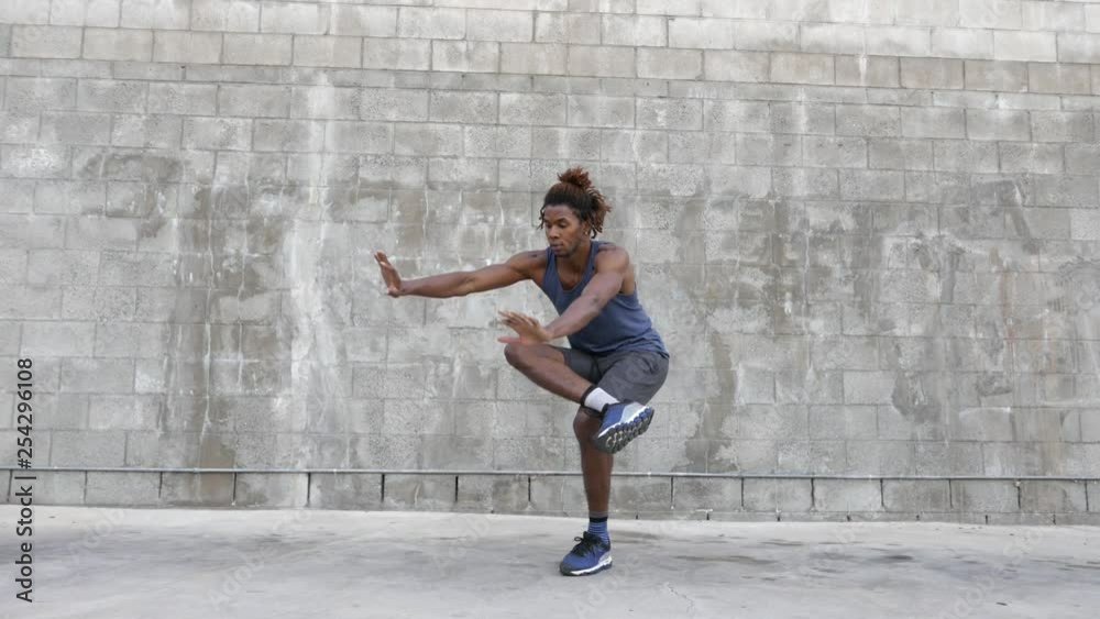 African American man performs yoga stretches before a run. African American man performs yoga stretches before a run.