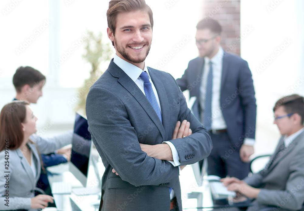 Happy businessman looking at camera with satisfaction at office Happy businessman looking at camera with satisfaction at office