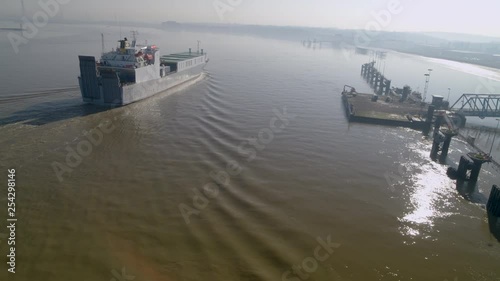 Aerial view of a cargo ferry sailing down the River Thames, England. photo