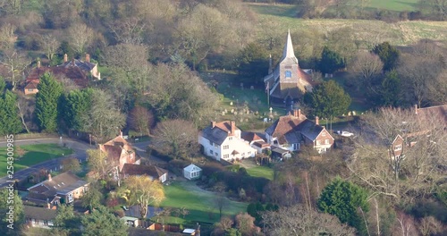 Aerial pullback from St Marys church in High Halden village, located in Kent (The Garden Of England) UK to reveal the British countryside. photo