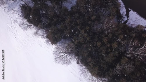 Top down drone footage over a forest in the winter. photo