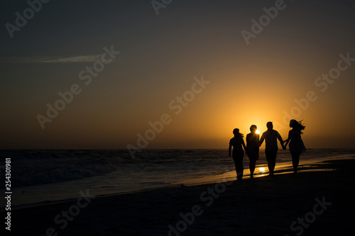 silhouette of family on the beach