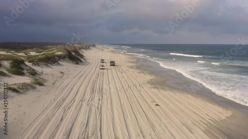 112 Aerial view of sandy road on the oceans beach. 4k