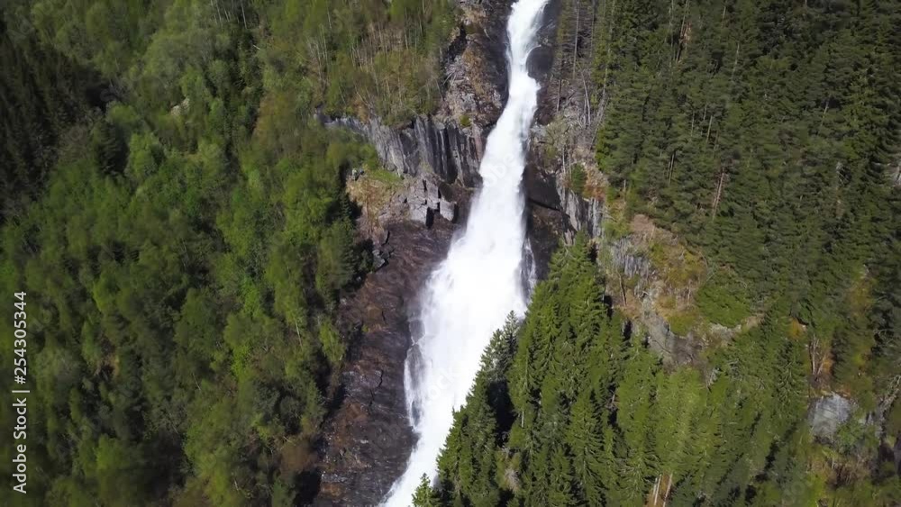 panning out from big waterfall in the middle of a green pinetree forrest, beautiful green scenery. stable and professional drone footage. panning out from big waterfall in the middle of a green pinetree forrest, beautiful green scenery. stable and professional drone footage.