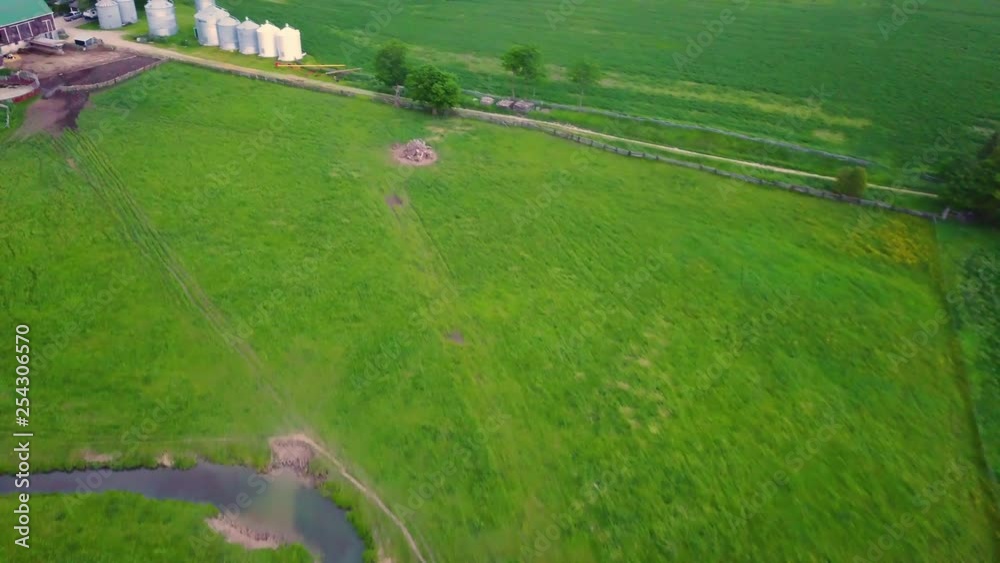 Drone flying over a large farm in the countryside. Drone flying over a large farm in the countryside.