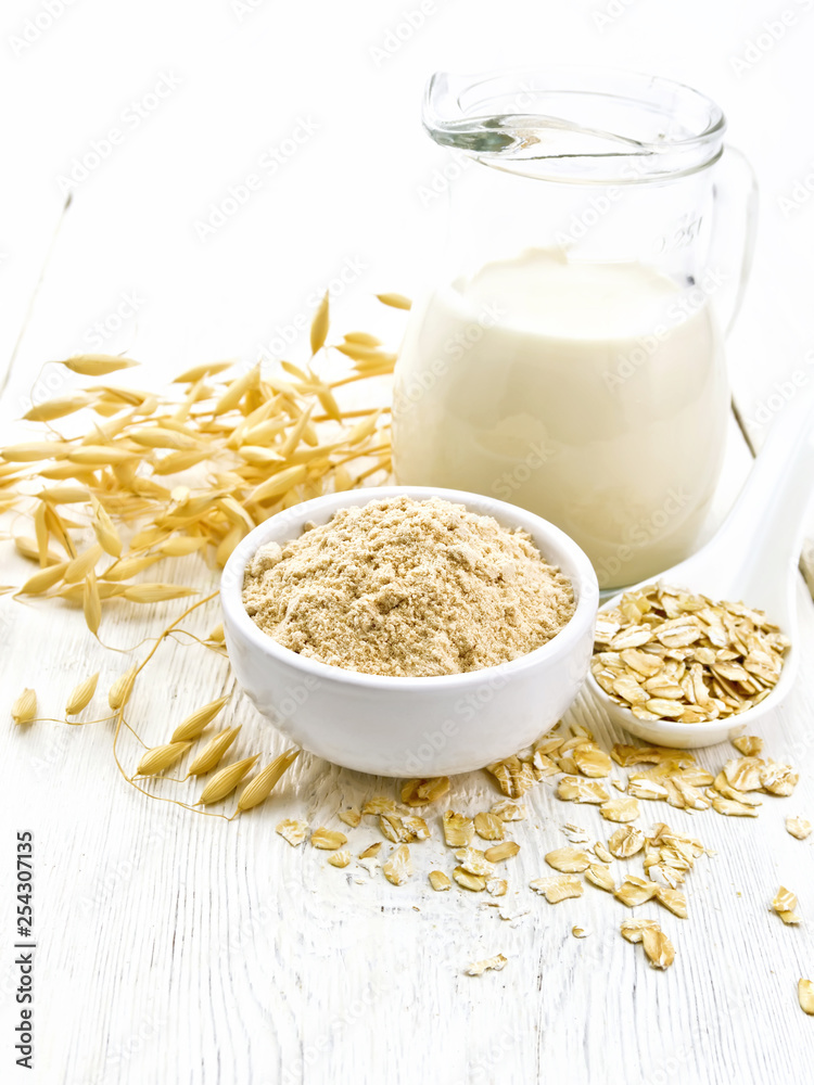 Flour oat in bowl with milk on light board Flour oat in bowl with milk on light board