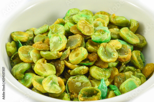 Cooked baked salt broad beans in cup isolated on white background - Wasabi beans green