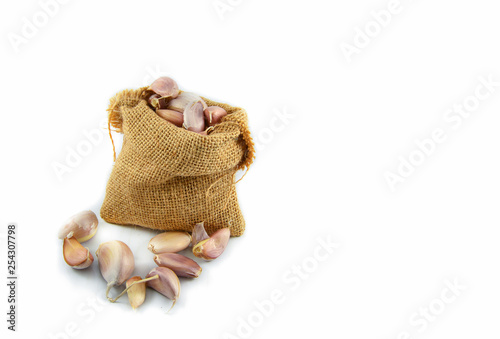 garlic in sack isolated on white background