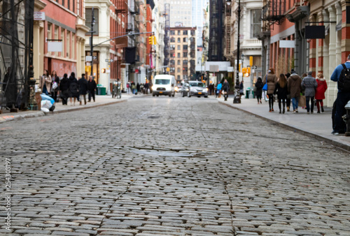 Photography View of cobblestone covered Greene Street with bright sunlight background in the