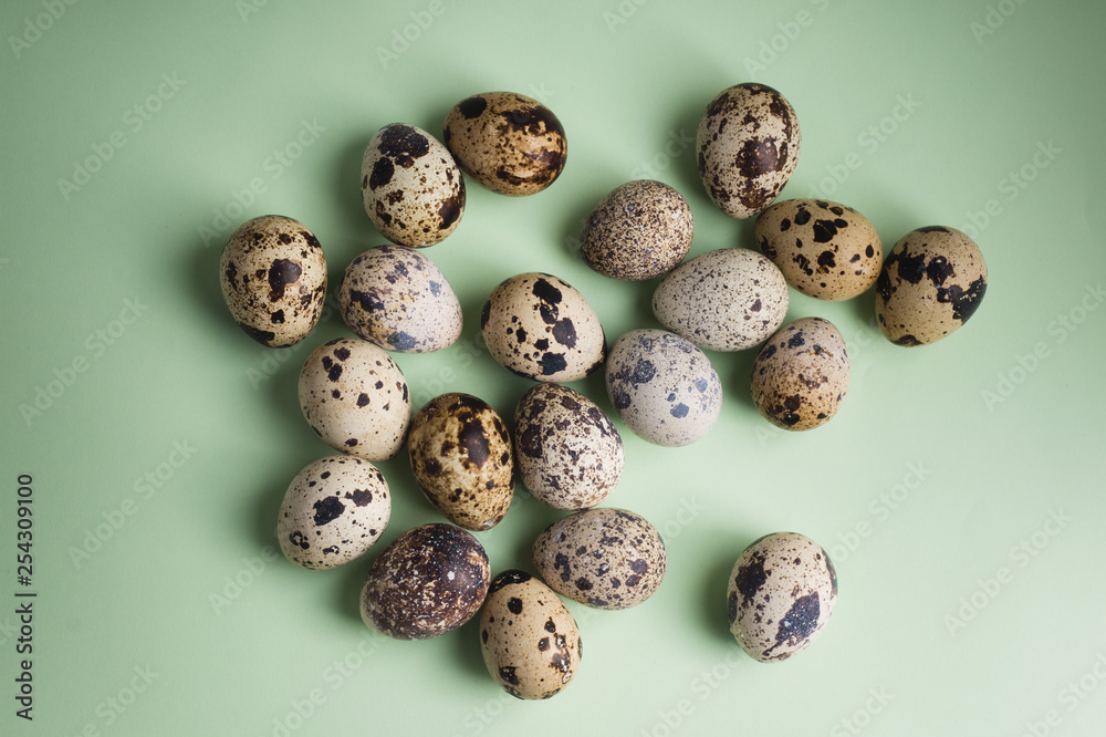 heap of quail eggs on color background. Vegetarian organic  eco food.