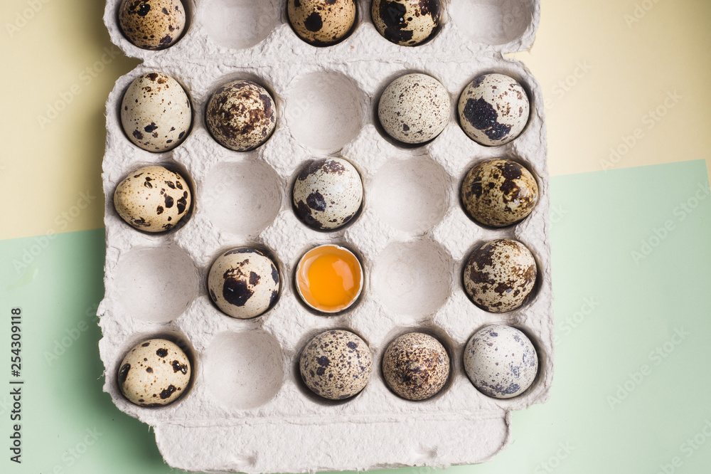 Quail eggs in random order with yolk in cardboard packaging..Vegetarian organic food. Eco products. Quail eggs in random order with yolk in cardboard packaging..Vegetarian organic food. Eco products.