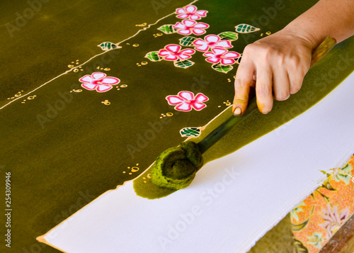 Painting watercolor on the fabric to make Batik, Making Batik, painting traditional batik photo