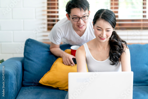 happiness asian sweet couple enjoy working at home together in living room home background