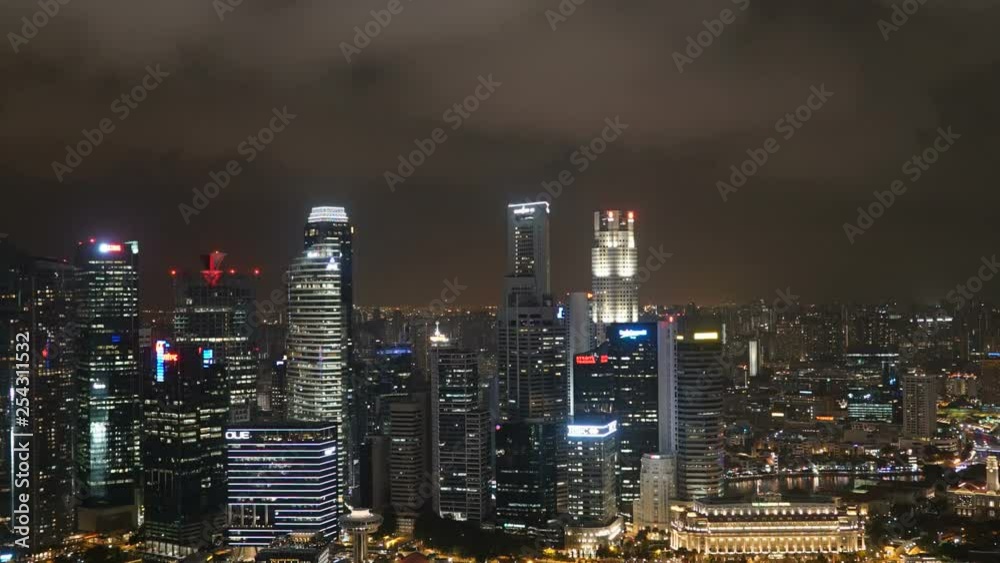 Time Lapse tilt up from the Singapore River to the city night lights to the cloud-filled sky. Concept: time, speed, atmosphere, lights night time Time Lapse tilt up from the Singapore River to the city night lights to the cloud-filled sky. Concept: time, speed, atmosphere, lights night time