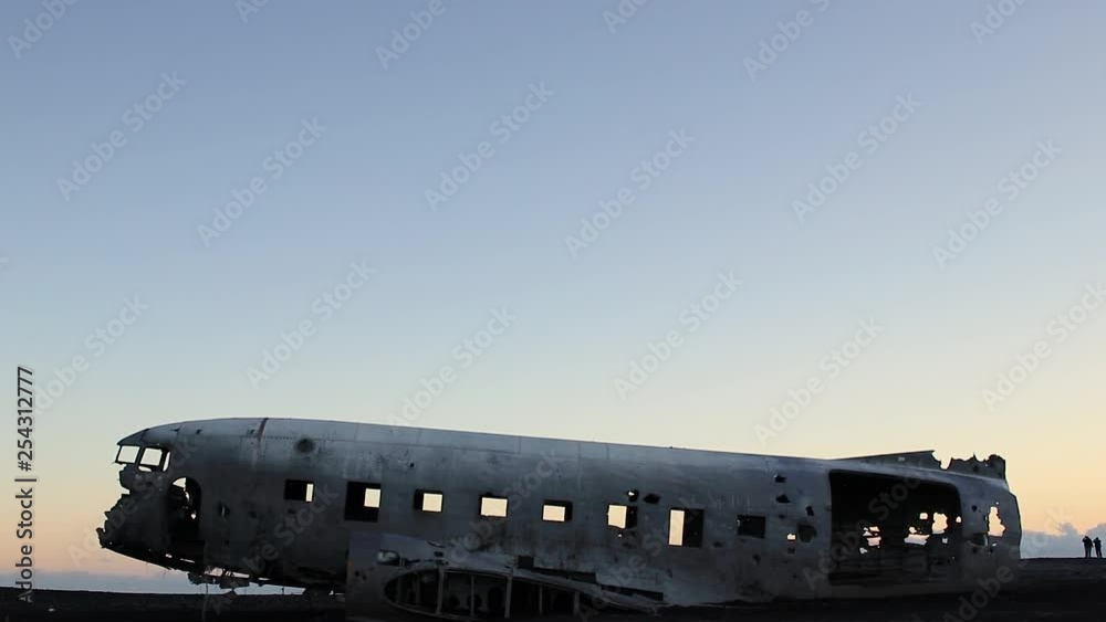 Crashed plane in southern Iceland outside Vik at a black sand beach during sunset. Famous tourist attraction and landmark while travelling Iceland.