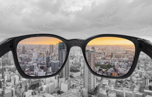 Looking through glasses to city view in sunset. Color blindness glasses, Smart glass technology