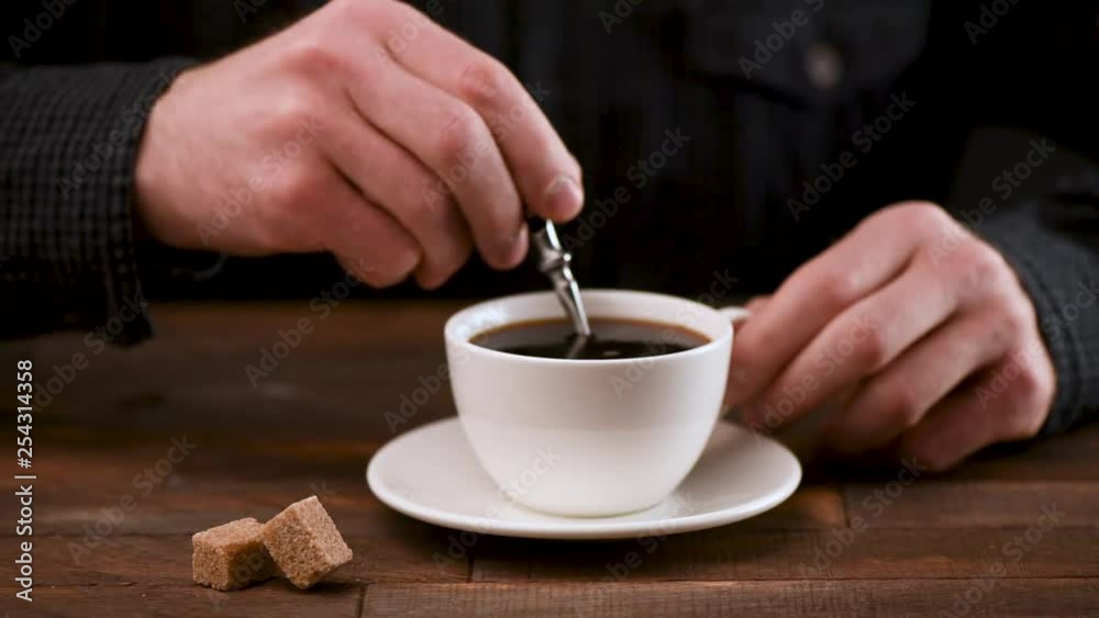 Person stirring sugar in coffee cup. Loop motion Person stirring sugar in coffee cup. Loop motion