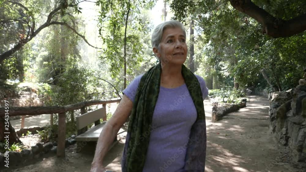 Senior citizen takes a walks through a park. Senior citizen takes a walks through a park.