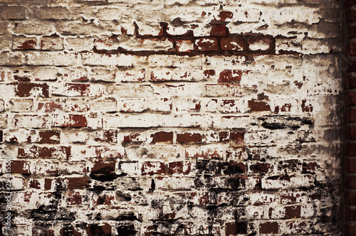 brick wall of old  red  rough brick with shabby white plaster