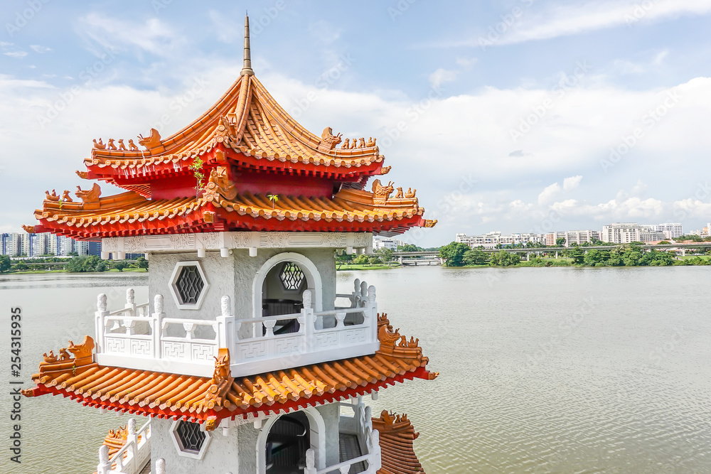 Naklejka premium The Twin Pagodas on Jurong Lake, in the Chinese Garden with cloudy sky in Singapore..