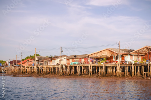 Wooden house of fishermen in south east of Thailand, beautiful scenery like painting and reflection on the surface, lifestyle and waterfront living, holiday travel and waterfront homes photo