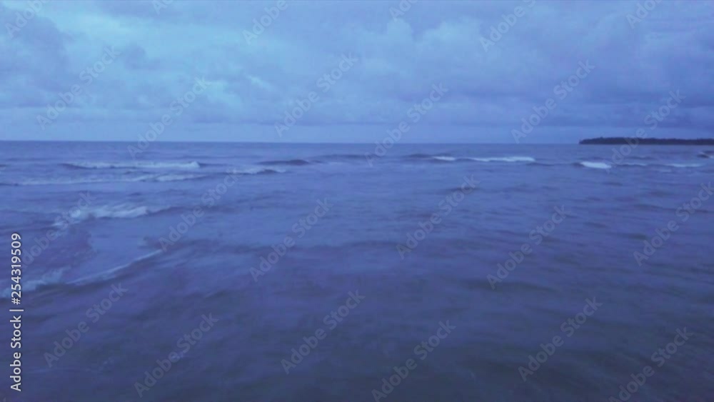 Aerial shot low level over waves of the Caribbean sea at dusk, Miguel de la Borda, Colon, Panama Aerial shot low level over waves of the Caribbean sea at dusk, Miguel de la Borda, Colon, Panama