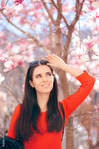 Happy Woman Enjoying Spring Sun Under a Magnolia Tree
