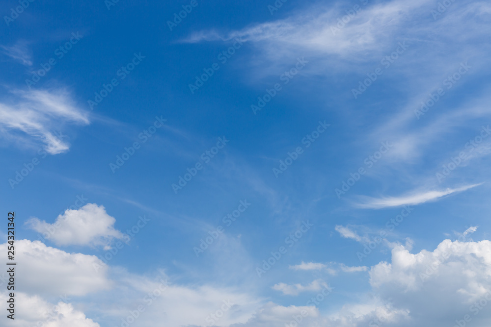 fluffy white cloud moving above clear blue sky