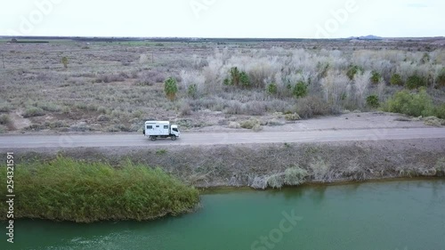 Drone flying along an RV Exploring vehicle driving along the all American Canal.