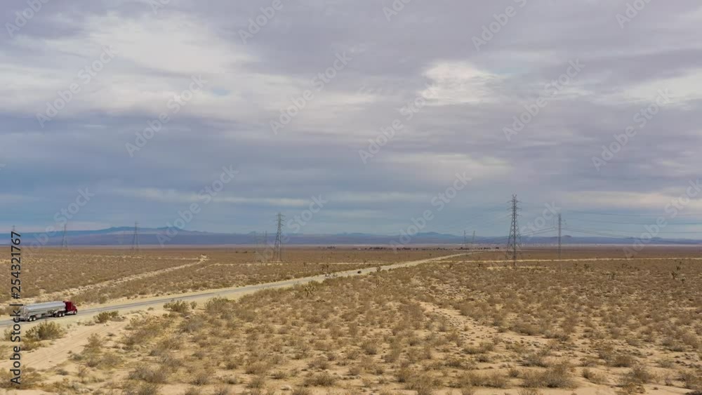 Semi Trucks transporting fuel and cargo through Mojave Desert plains, Aerial Semi Trucks transporting fuel and cargo through Mojave Desert plains, Aerial
