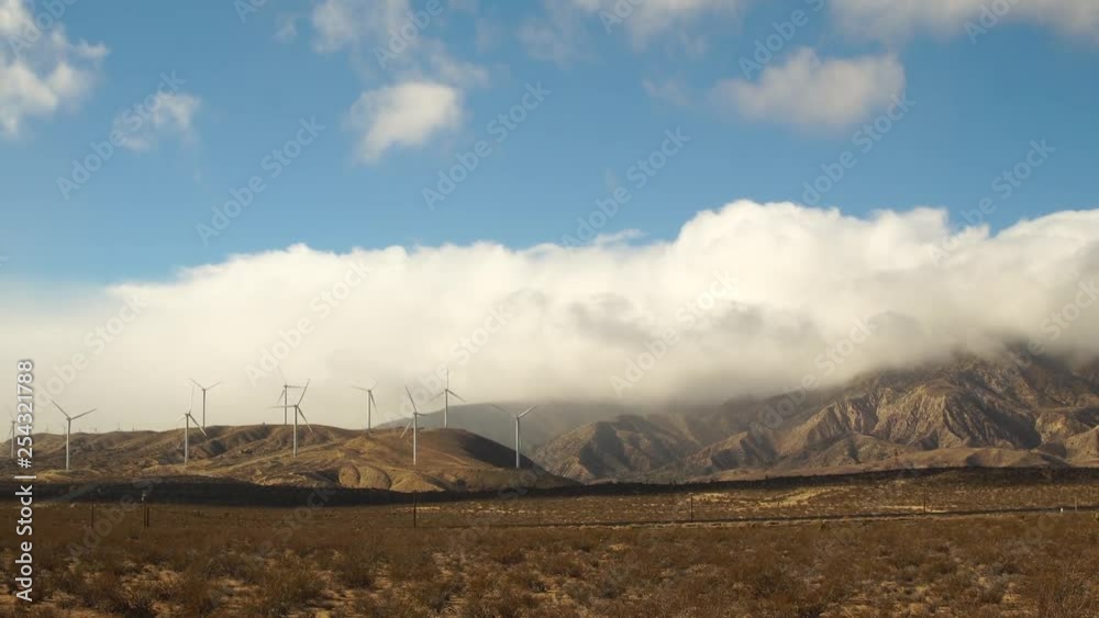 Timelapse of Windmills spinning with thick clouds over Mojave Desert mountains Timelapse of Windmills spinning with thick clouds over Mojave Desert mountains