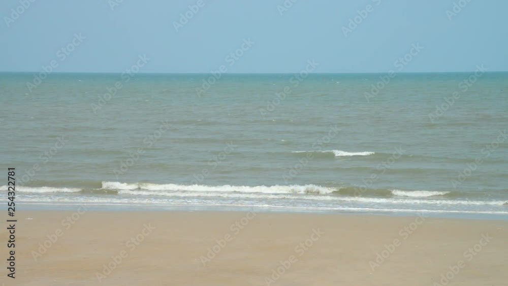 Light palette sandy textured beach with light waves hitting the shoreline, medium shot Light palette sandy textured beach with light waves hitting the shoreline, medium shot