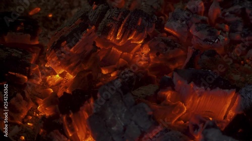 A warm and moody feel. The light seems to dance in the hot coal that glows from a previous fire.