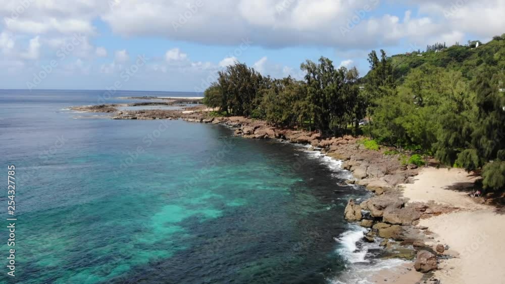 Drone flying over the beautiful North Shore beach in Oahu Hawaii, Waimea Beach Bay Drone flying over the beautiful North Shore beach in Oahu Hawaii, Waimea Beach Bay