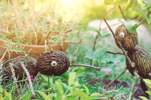 An artificial ant statue made from coconut, decorated on trees in the garden.