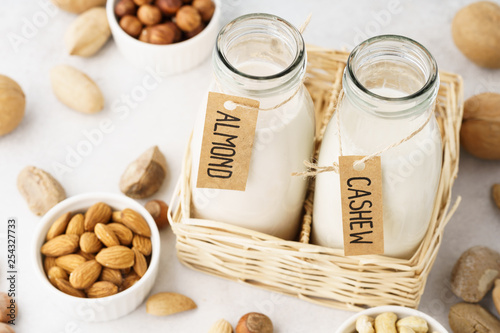 Vegan milk made of nuts in glass bottles - almond and cashew. photo