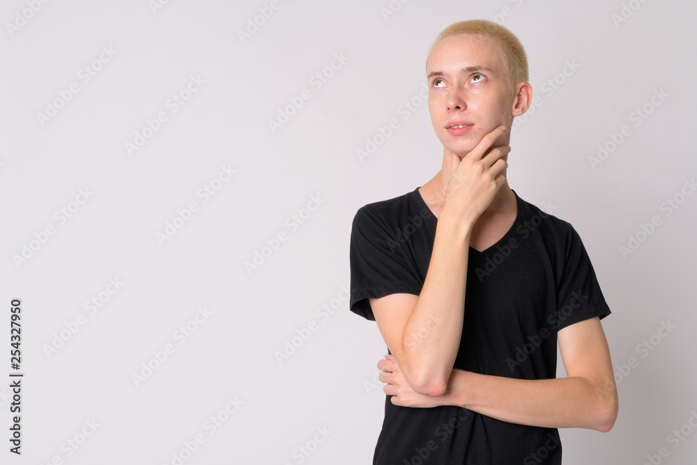 Portrait of young happy androgynous man thinking Portrait of young happy androgynous man thinking