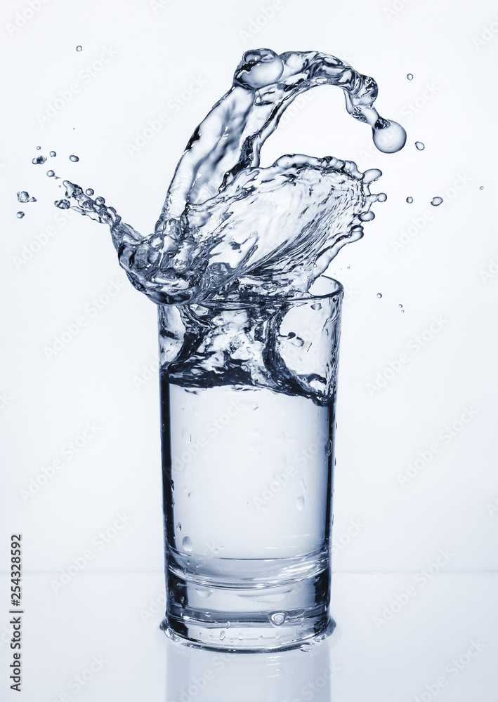 Glass with splashes of water. Splashing water. Copy space. Glass with splashes of water. Splashing water. Copy space.