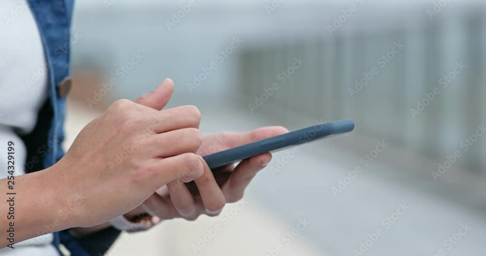 Woman touch on smart phone in city Woman touch on smart phone in city