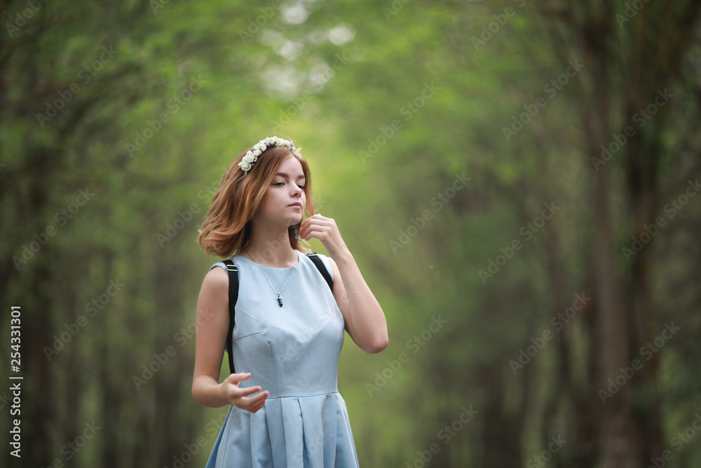Girl in blue dress in green park Girl in blue dress in green park