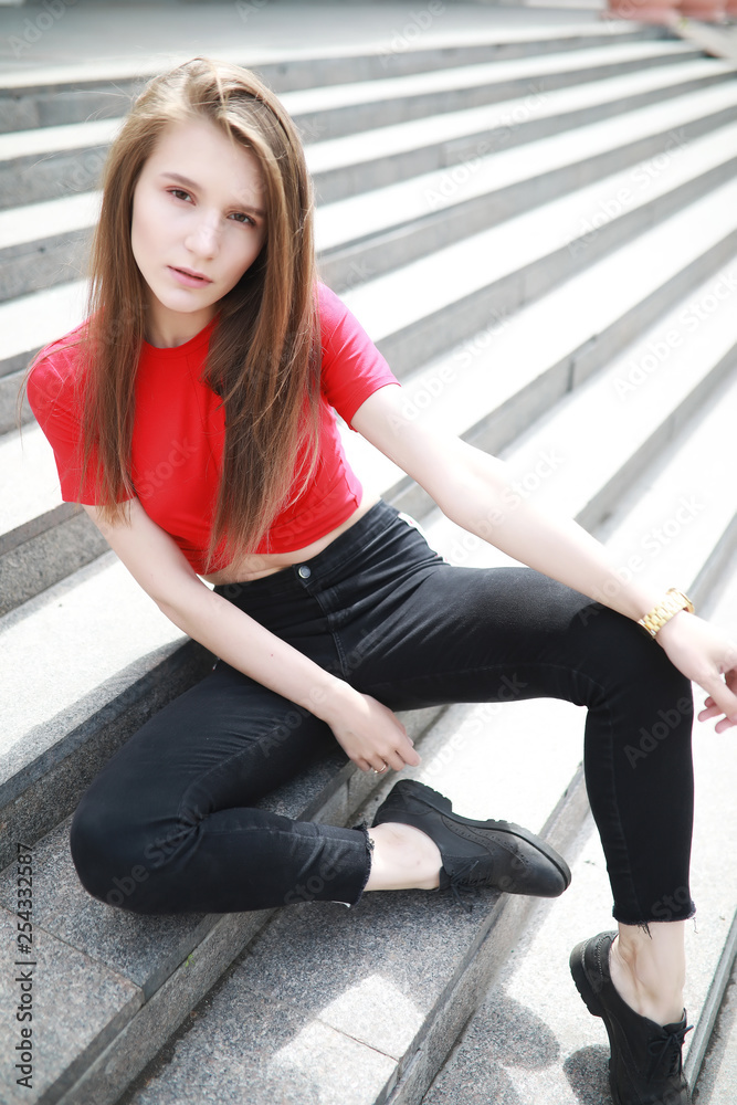 A girl posing on the steps of a building